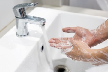 Hygiene. Cleaning Hands. Washing hands with soap under the faucet with water.