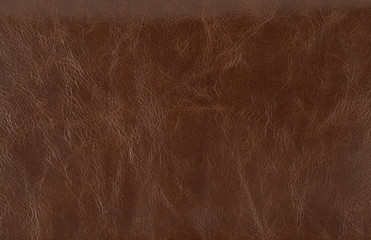 The texture is smooth, patent tanned brown leather