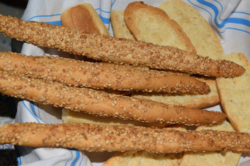 basket with bread and grissini with sesame