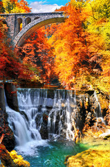 Autumn landscape.The famous Vintgar gorge canyon with wooden pats, beauty of nature, with river Radovna flowing through it, and the old bridge ,near Bled,Triglav,Slovenia,Europe