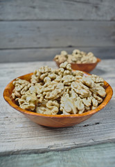 Walnut kernels in brown bowls