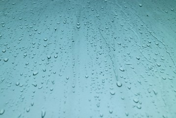 Rain drops on the window in rainy day. Selective focus. Background concept.