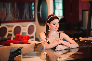 Portrait of beautiful woman holding glass of martini