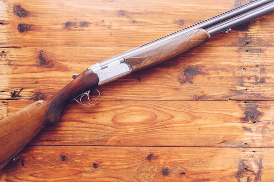 Hunting rifle isolated on wooden background