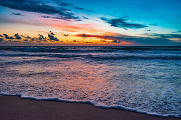 Naklejka na ściany i meble colorful morning at the beach just before sunrise