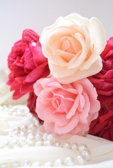 wedding bouquet,  bouquet of roses of different colors and varieties on a soft drape and pearl beads