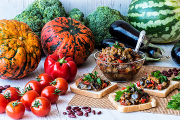 Vegetarian food. stewed vegetables on bread and in a plate. saute from eggplant.