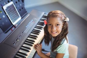 Portrait of elementary girl practicing piano
