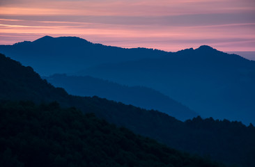 spectacular landscape with reddish sky at dawn in mountains