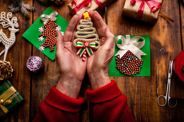 hands of senior woman making handmade New Year's or Christmas gifts and decorations with vintage effect