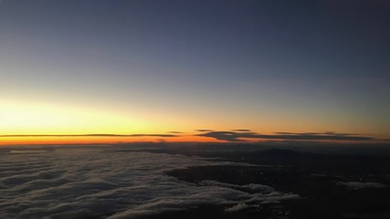 Sunset over the sea of clouds from the plane