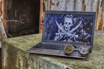 Laptop with a picture of a pirate flag 