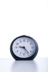 Isolated clock on table.