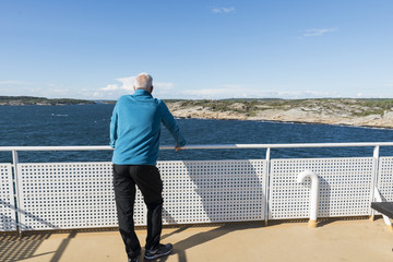 adult man in blue sweater on ferry