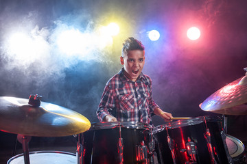 Drummer playing the drums with smoke