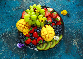 Colorful Mixed Fruit platter with Mango, Strawberry, Blueberry, Kiwi and Green Grape. Healthy food