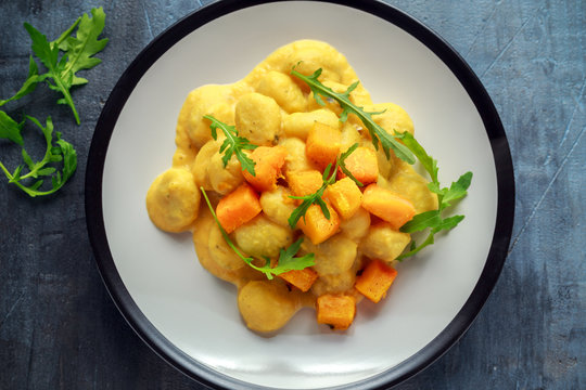 Homemade Butternut squash gnocchi with wild rocket in a plate