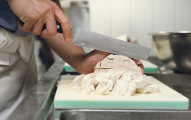 Fototapeta na wymiar Chef professional cut taro on cutting board with knife japan