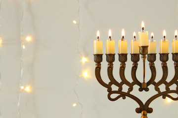 Fototapeta premium Image of jewish holiday Hanukkah background with menorah (traditional candelabra)