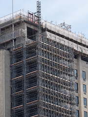 Scaffolding tower provideing access for work in progress on a high rise block in UK