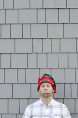 Christmas disappointment. Man with a sad face wearing a Christmas hat.