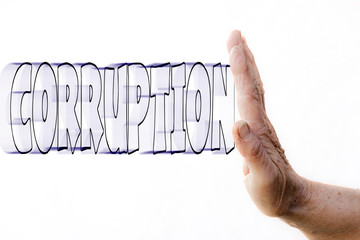 The hand of a woman is stopping the word CORRUPTION that is coming to it with high speed