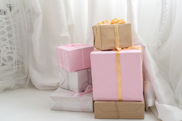Boxes with Christmas presents on the floor, free space. Gift boxes with ribbons, copy space. Christmas, New year, birthday holidays concept. Congratulations on Women's day, mum's day, Valentine's day