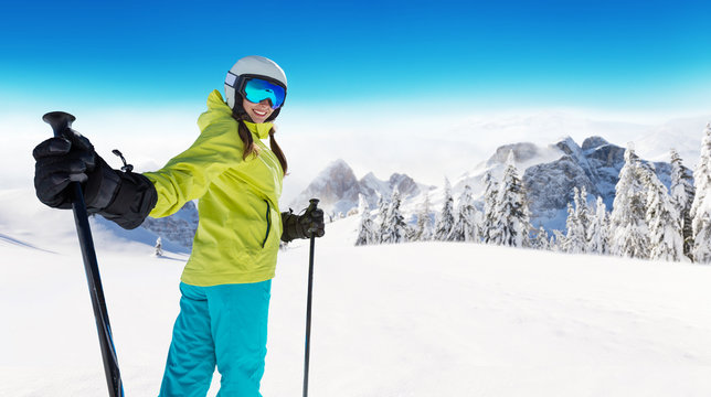 Happy young woman skier enjoying sunny weather in Alps