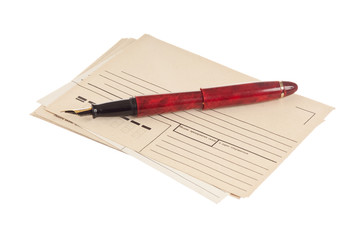 stack of mail envelopes and a pen