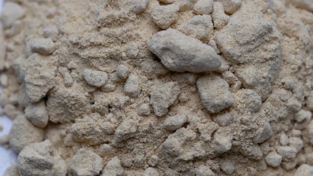 Heap of Maca powder rotating on white background. Close up