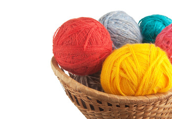 ball of wool and knitting needles in basket isolated on a white  background