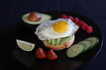 Avocado toast with tomatoes, cucumber, lime and raspberries