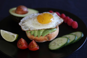 Avocado toast with tomatoes, cucumber, lime and raspberries