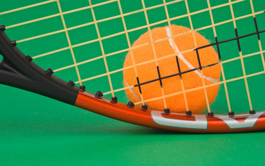 tennis racket and  ball on green background