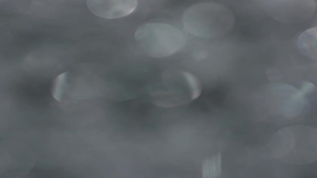 The Anamorph Bokeh stock video features a circle rotation in a clockwise direction of grey blurred lights. You can use it as an overlay for creative video effects, artistic videos, and as a texture by
