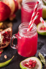 Pomegranate drink on a wooden background. Selective focus.