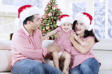 Happy family playing together on the couch