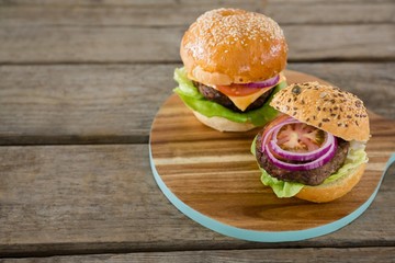 High angle view of burgers on cutting board