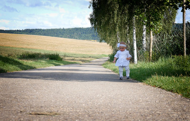 the child is sitting on the road