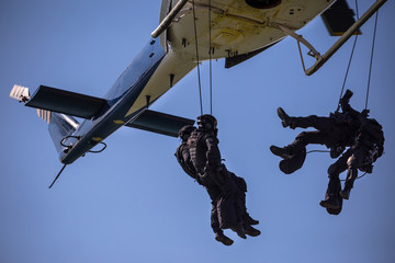 Special forces team helicopter rope jump
