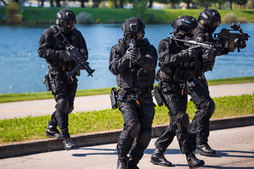 Special forces tactical team of four in action - obrazy, fototapety, plakaty