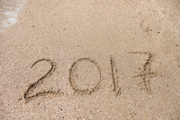 Inscription 2017 on the sand