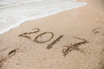 Inscription 2017 on sand of a sea beach