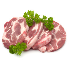 Raw pork neck chop meat with parsley herb leaves garnish isolated on white background cutout