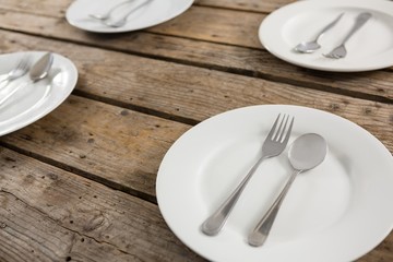 Close up of spoons and forks in plate