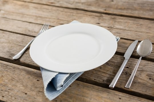 Close up of plate and cutlery with napkin