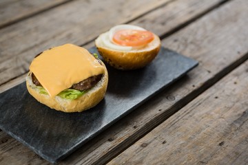 Cheese and meat with buns on slate