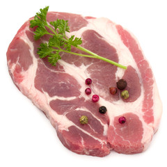Raw pork neck chop meat with parsley herb leaves and peppercorn spices garnish isolated on white background cutout