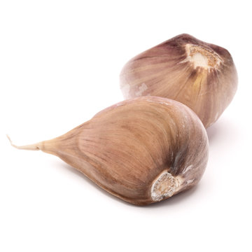 Two garlic cloves isolated on white background cutout