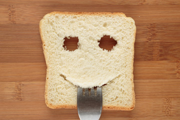 Happy toast with a fork in her mouth